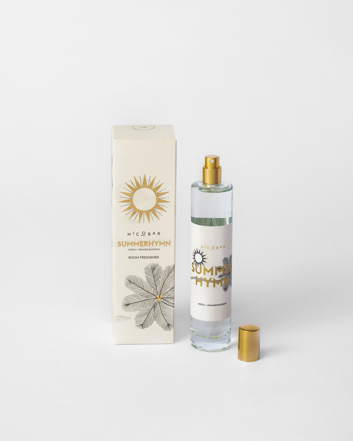 Summerhymn Room Spray bottle with its gold cap removed beside its box.