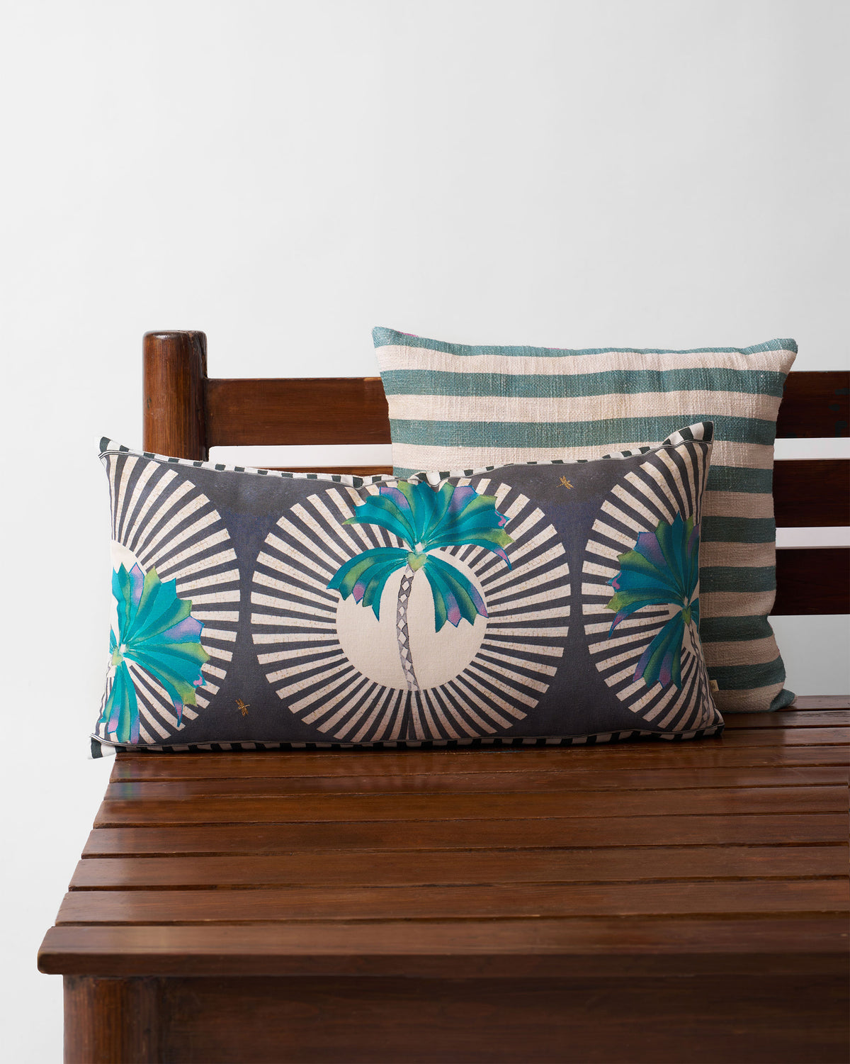 Swaying Palm Cushion Cover in navy with teal palm motifs and cream sunburst stripes.