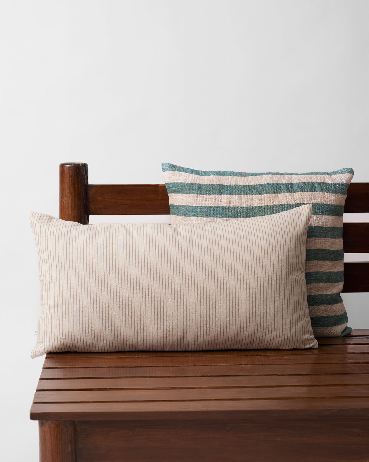 Back of the Swaying Palm Cushion Cover in cream pinstriped fabric.