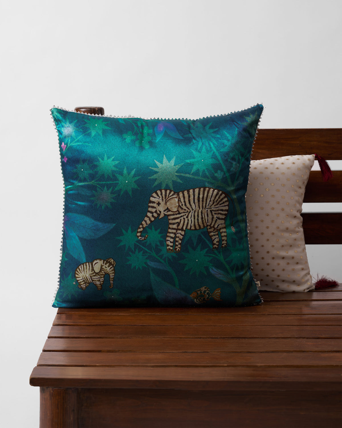 Tusk Cushion Cover in teal with a striped elephant and star motifs.
