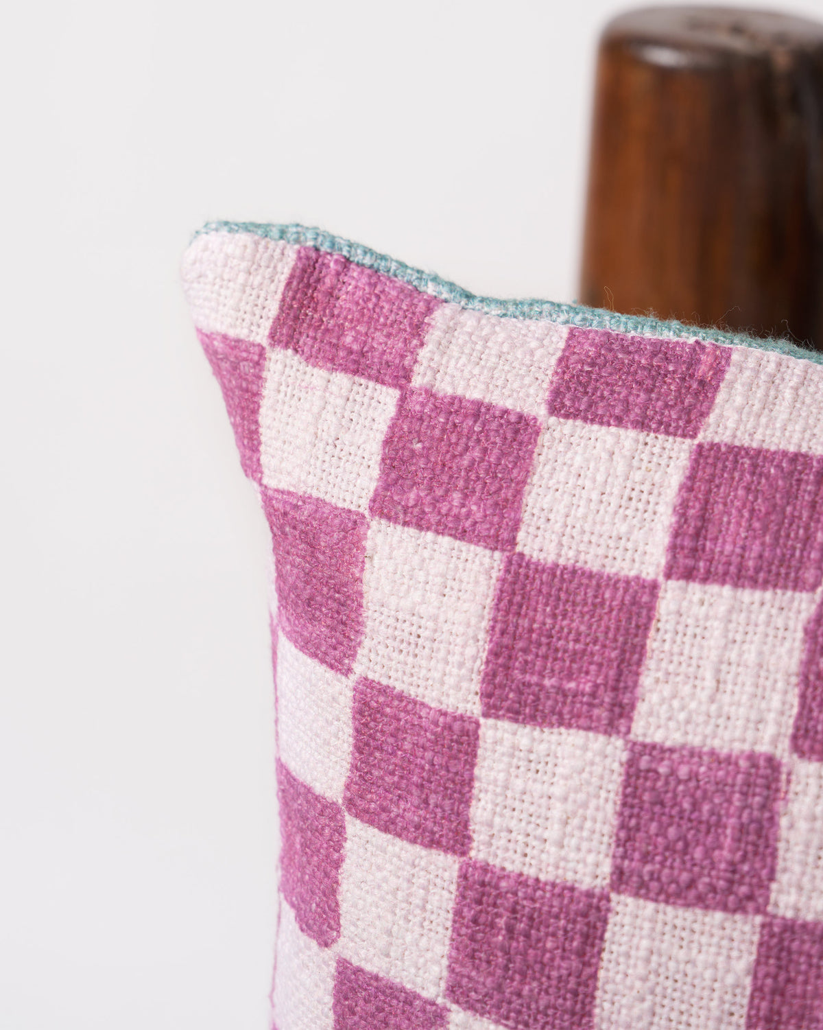 Close-up of the Mogra Bloom Cushion Cover corner showing its mauve checkerboard weave.