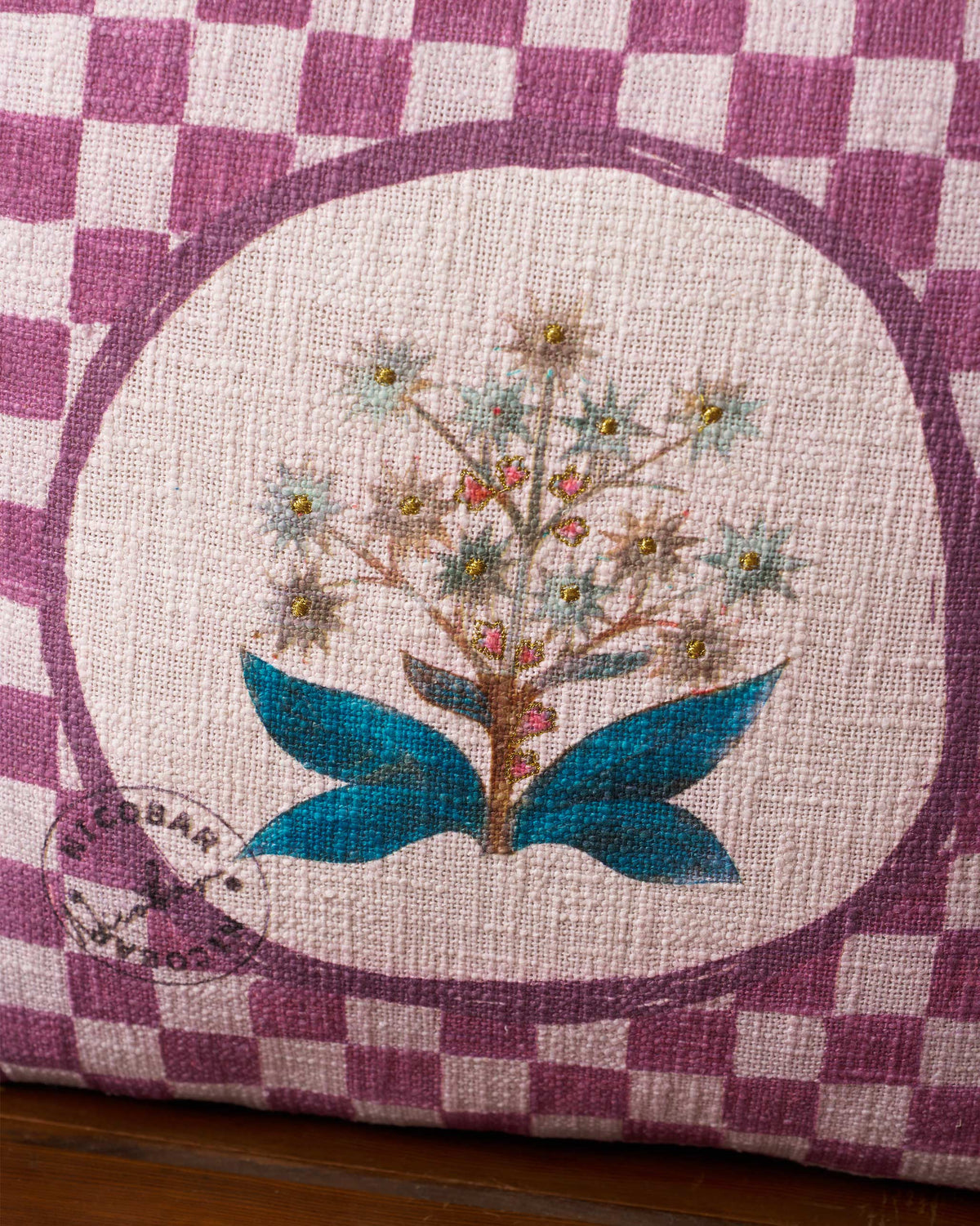Close-up of the Mogra Bloom Cushion Cover showing its flower motif with teal leaves.
