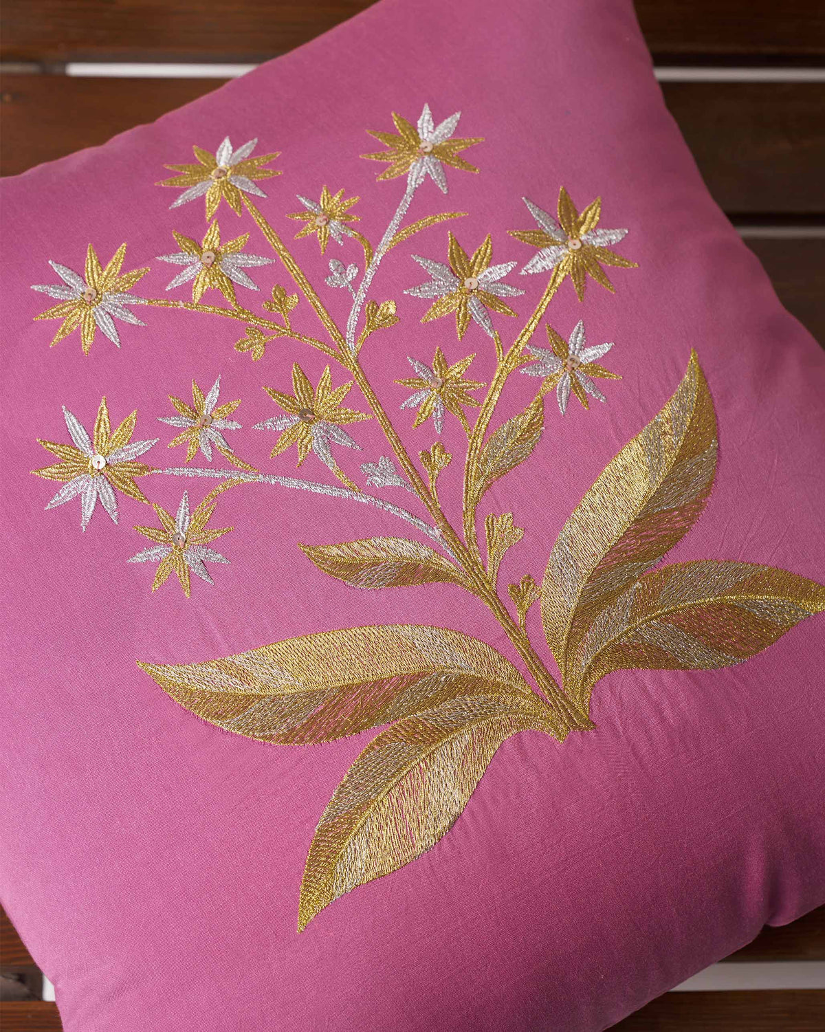 Close-up of the Mogra cushion cover showing gold and silver flower embroidery.