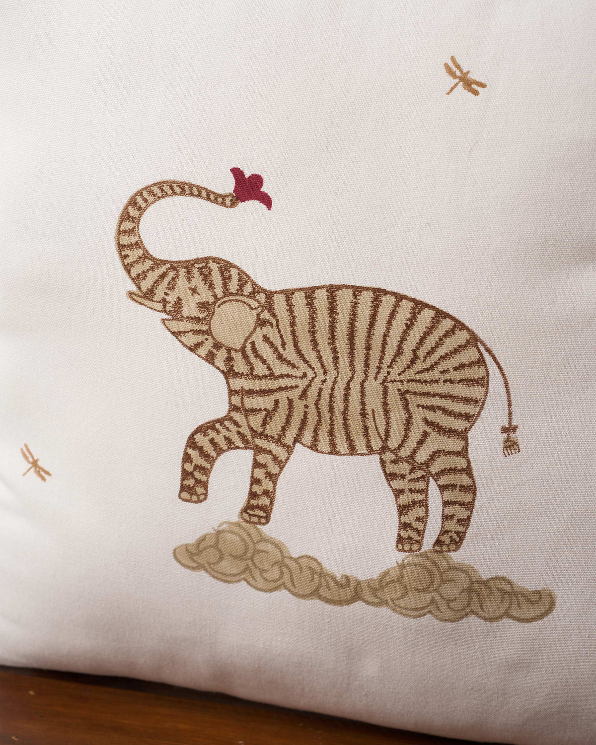 Close-up of the Marching Ele Cushion Cover showing a striped elephant on a cloud.