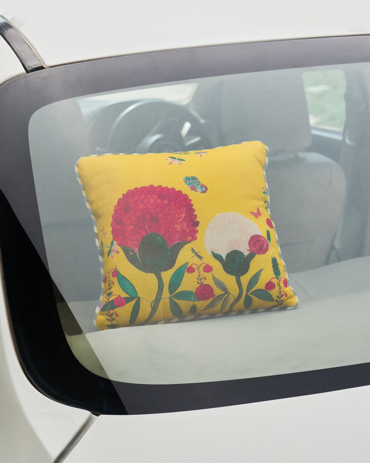 Winter Wonderland Car Cushion in use in a car, showing its pink flower print.