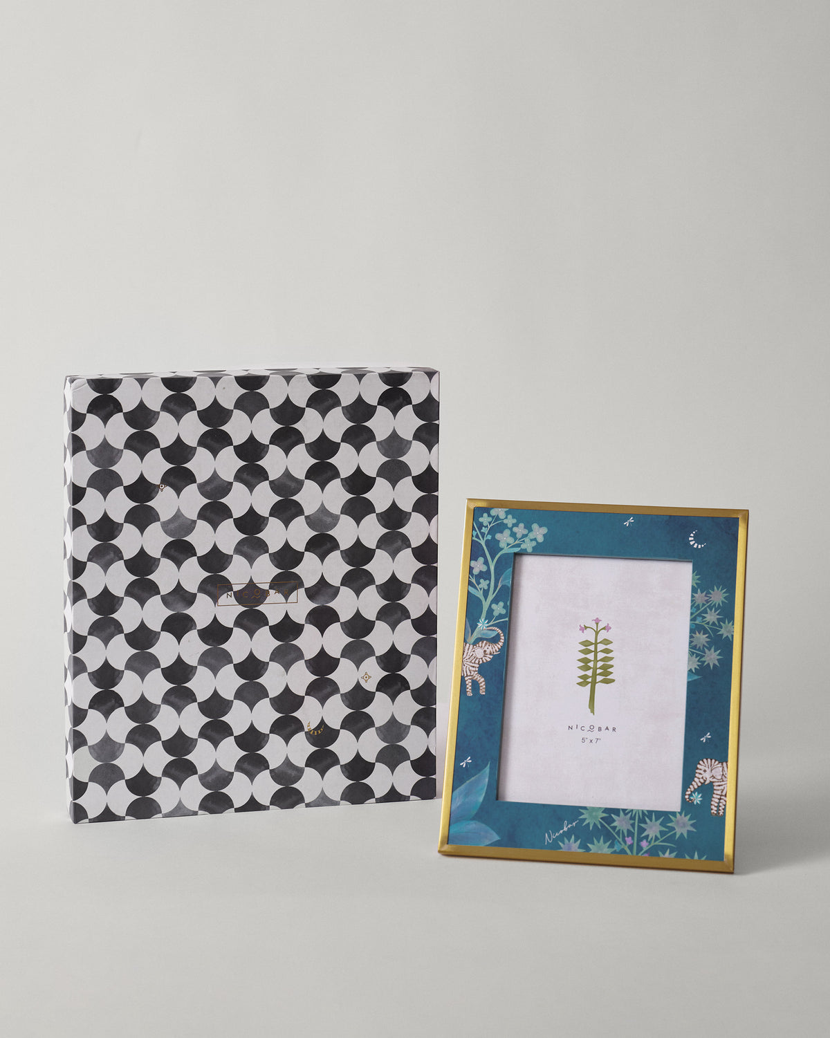 Midnight Tusk photo frame standing beside its patterned gift box.