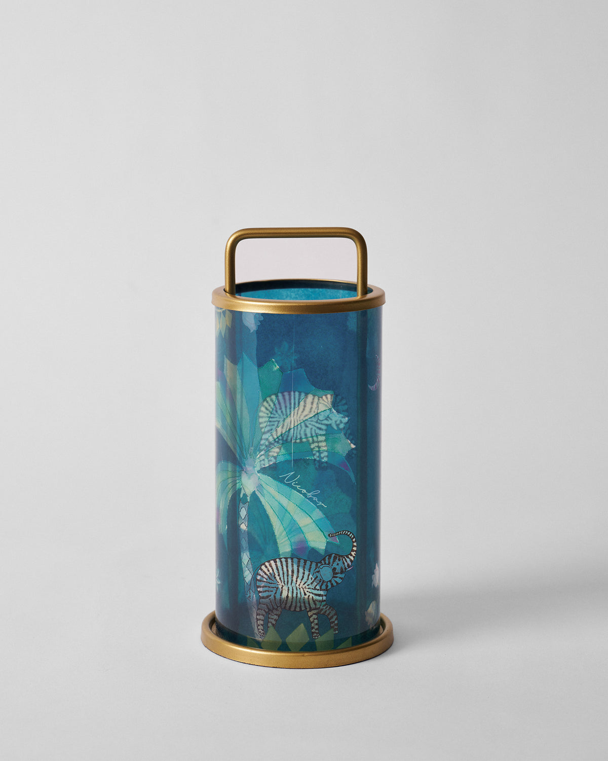 Teal Palm Bloom lantern with striped elephant motif and a gold metal handle.
