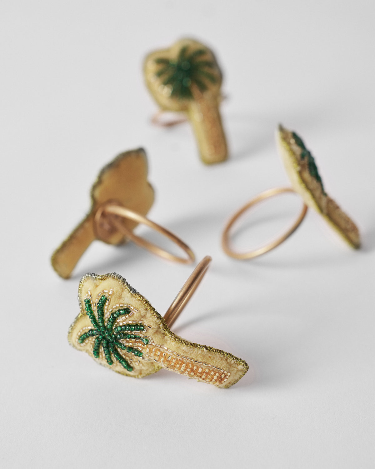 Palm napkin ring showing beaded palm patch on a copper hoop.