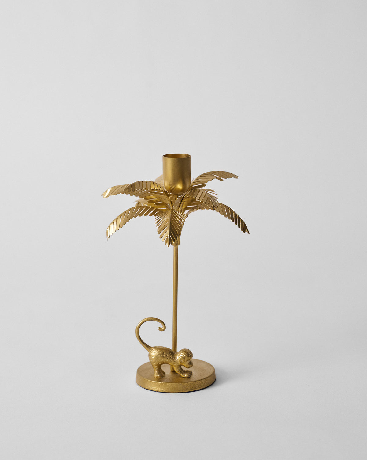 Gold Palm Bloom candle holder shaped like a palm tree with a monkey at the base.