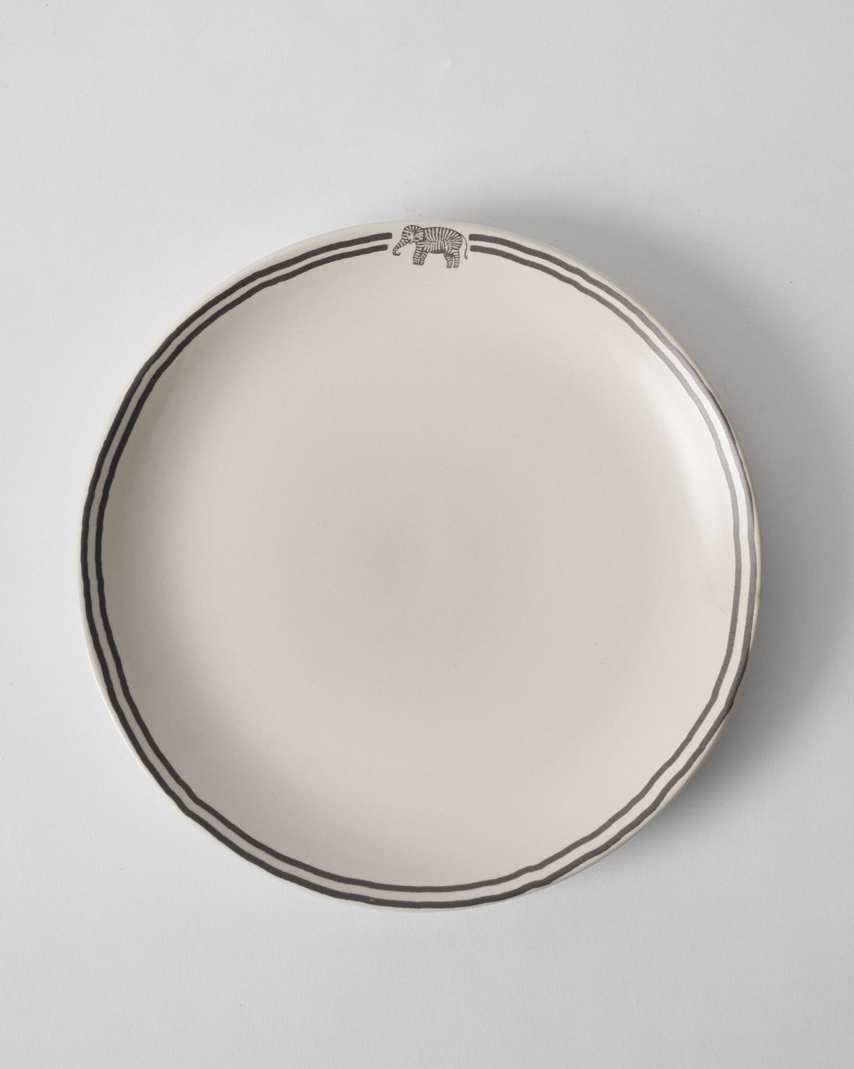 Tusk Dinner Plate with a grey elephant motif and double rim lines.