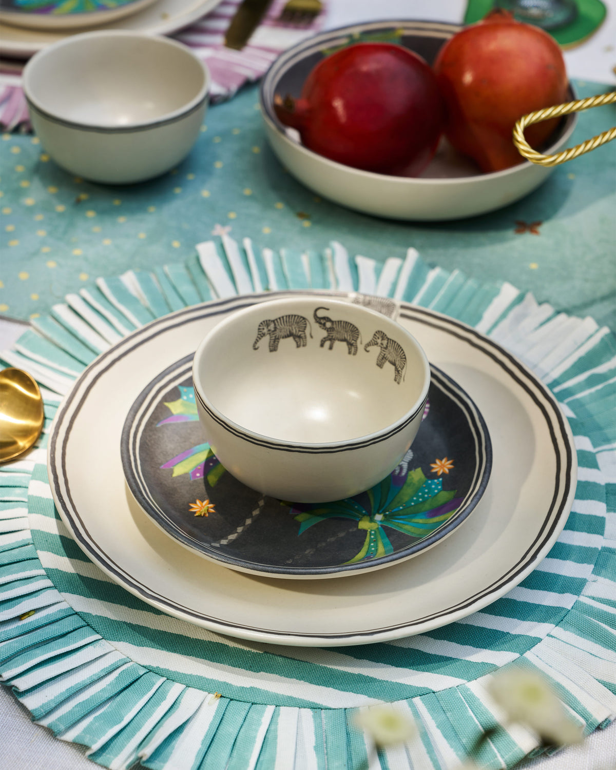 Tusk Katori set on a plate, with elephant motifs visible inside the bowl.