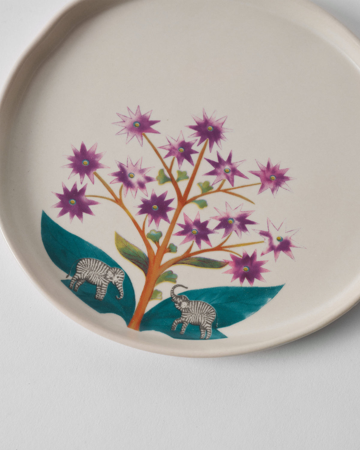 Close-up of the Mogra Dessert Plate showing its flowers and two small elephants.