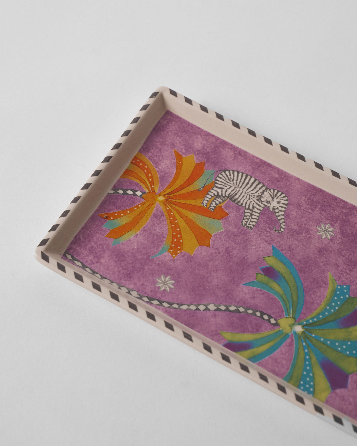 Close-up of striped elephant and palms on the Tusk cookie tray.