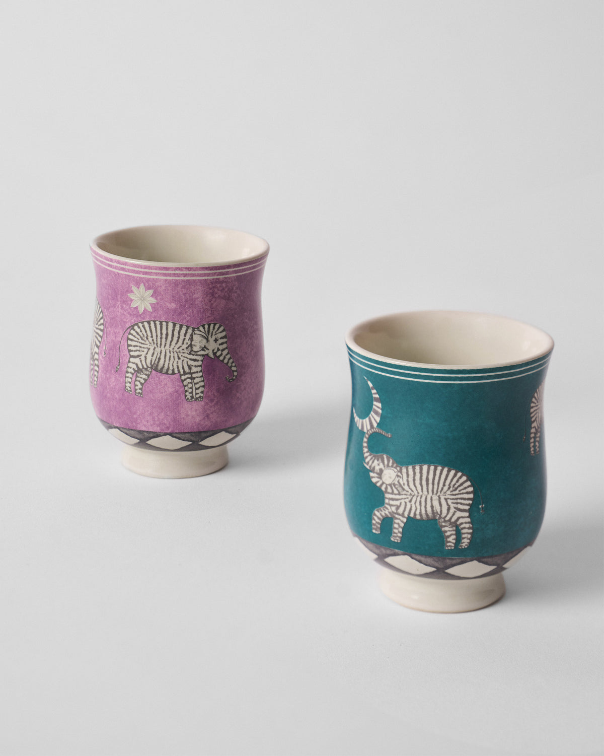Tusk tea cups showing zebra-striped elephants with moon and star.