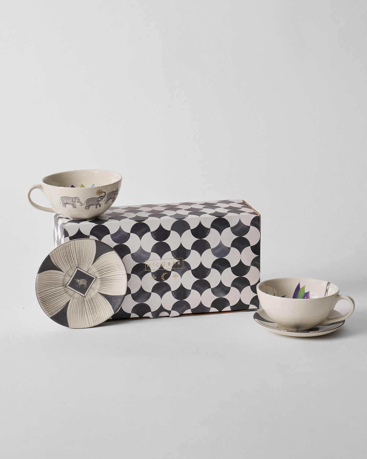 Palm Bloom coffee cup and saucer set with a Nicobar scalloped gift box.