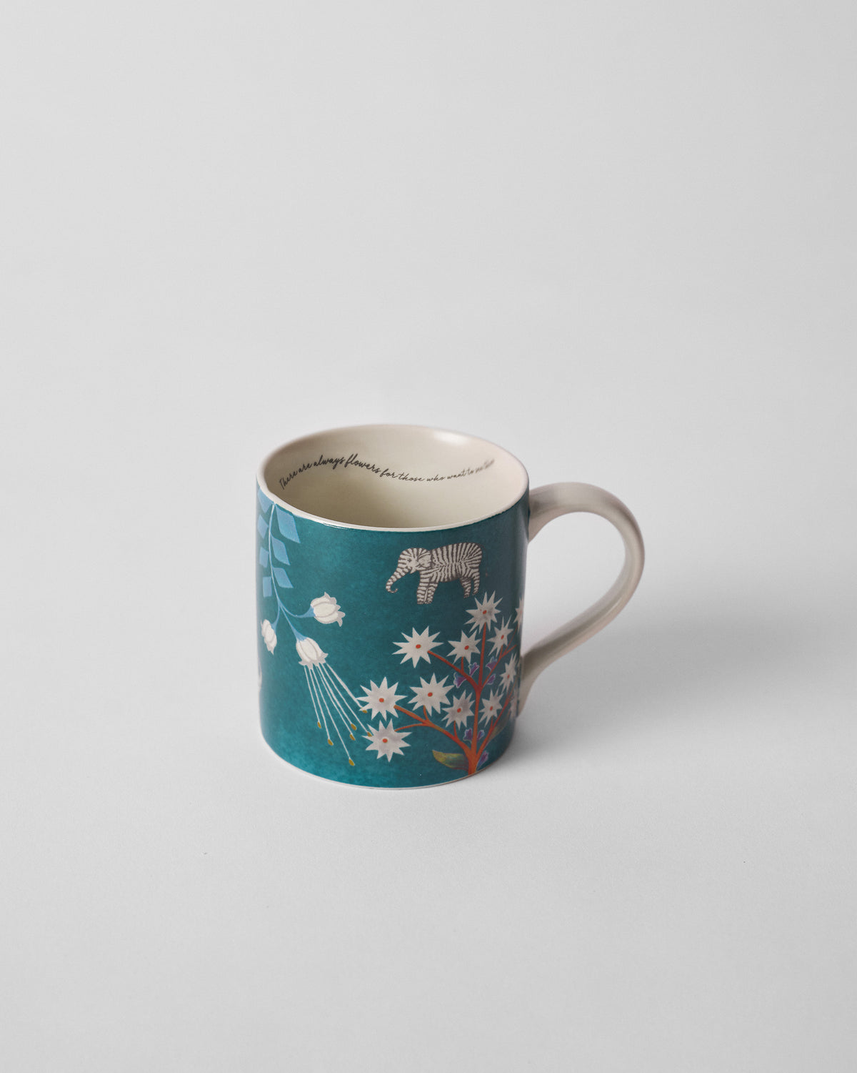 Tusk Bloom Straight Mug in teal with a zebra and white flower trees.