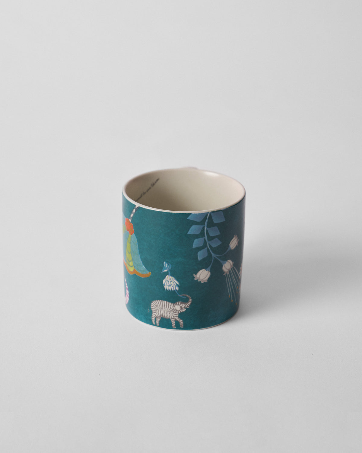 Side view of a Tusk Bloom Straight Mug with a zebra motif on teal.