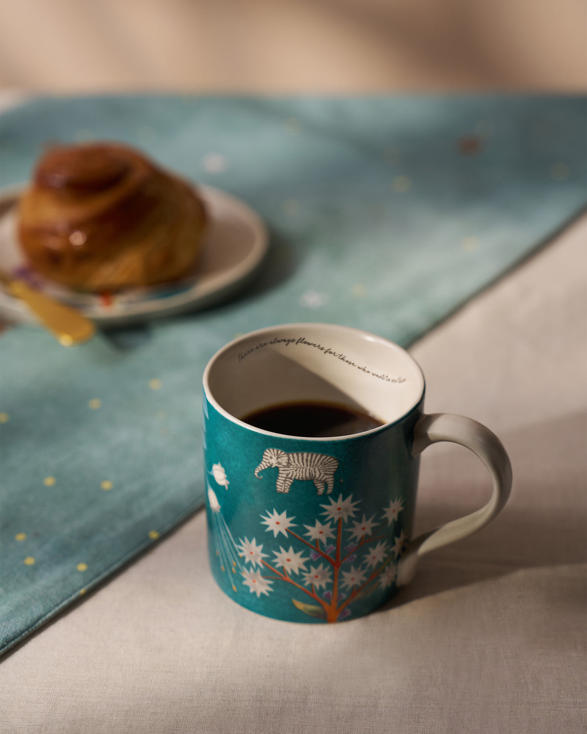 Tusk Bloom Straight Mug filled with black coffee, with a zebra and flower print.