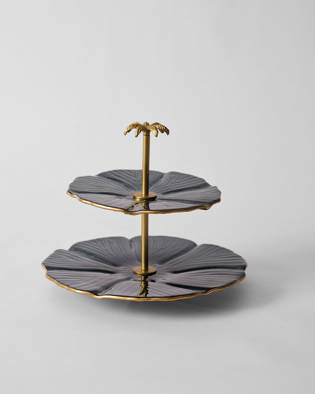 Phool Cake Stand - Charcoal with two charcoal leaf-shaped tiers and a gold palm top.