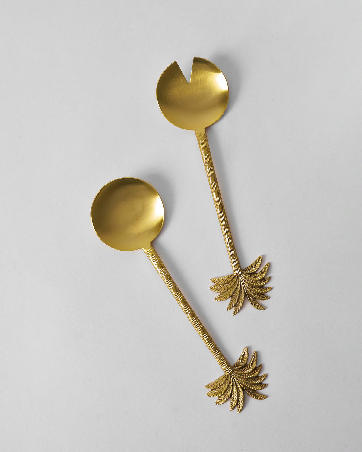 Gold Palm Bloom salad spoon and notched server shown at full length.