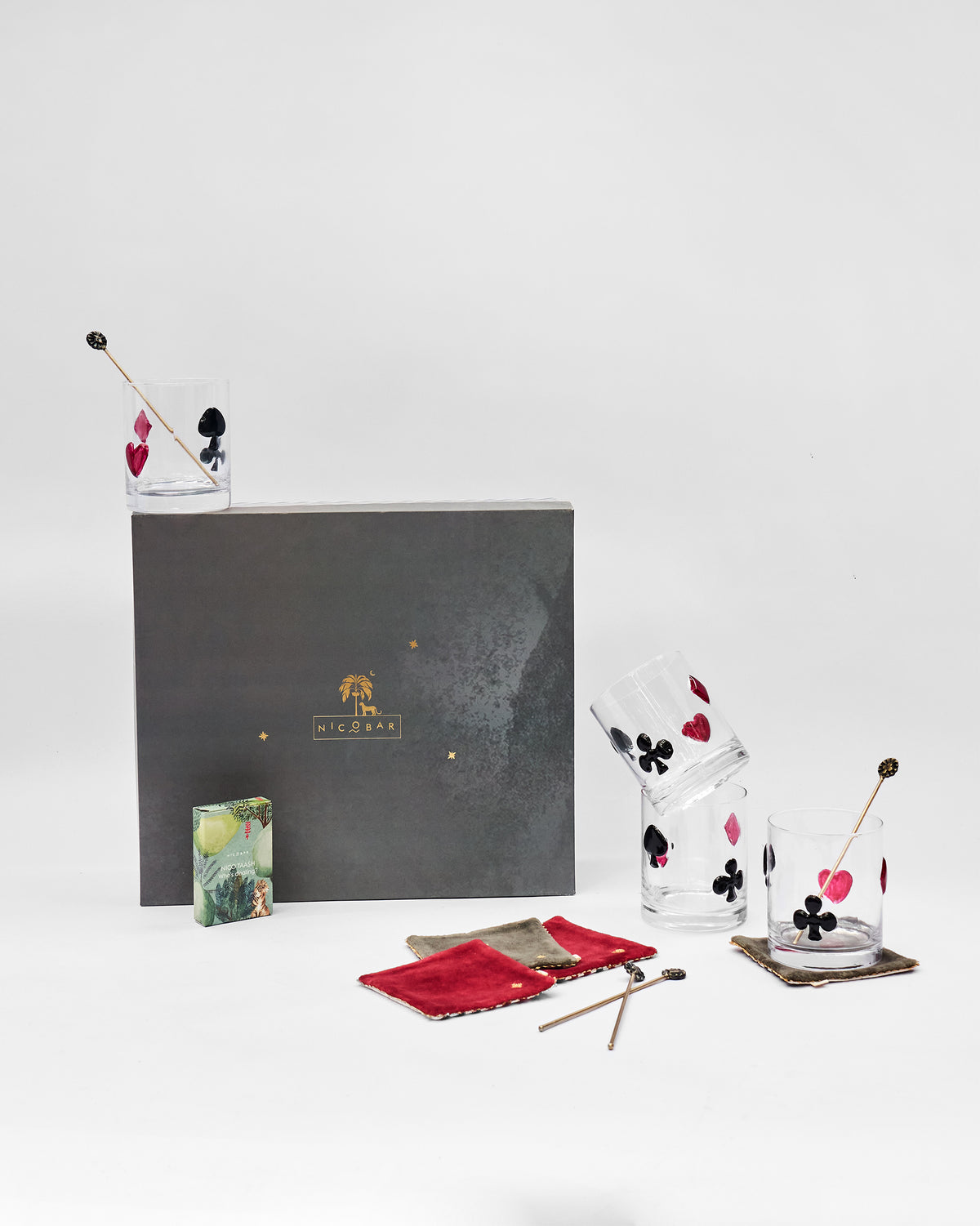 Mehfil bar gift set with card-suit glasses, stirrers, and velvet coasters.