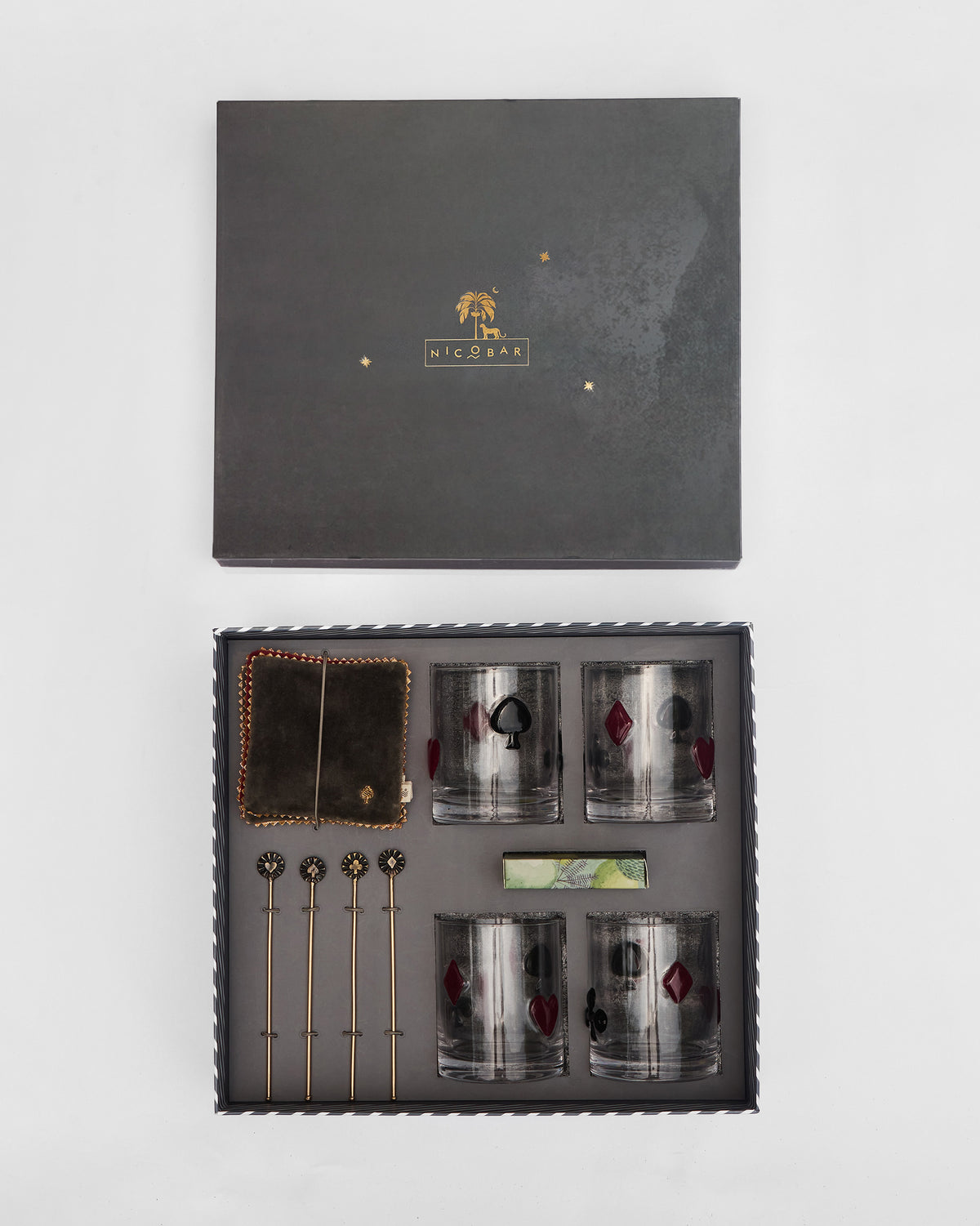 Open Mehfil bar gift set showing glasses, brass stirrers, and coasters.
