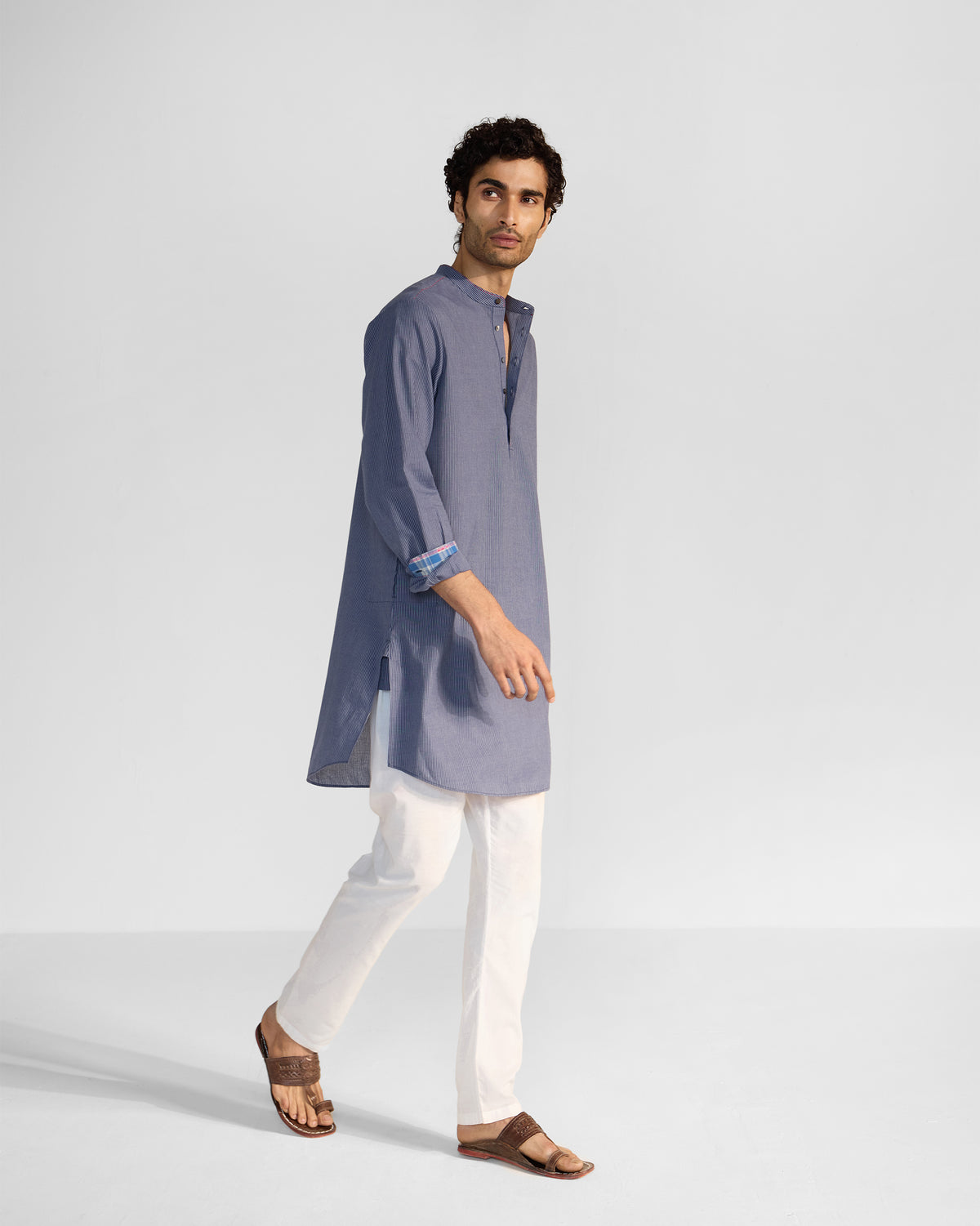 Side view of a navy and white striped Nysa Kurta showing the side slit.