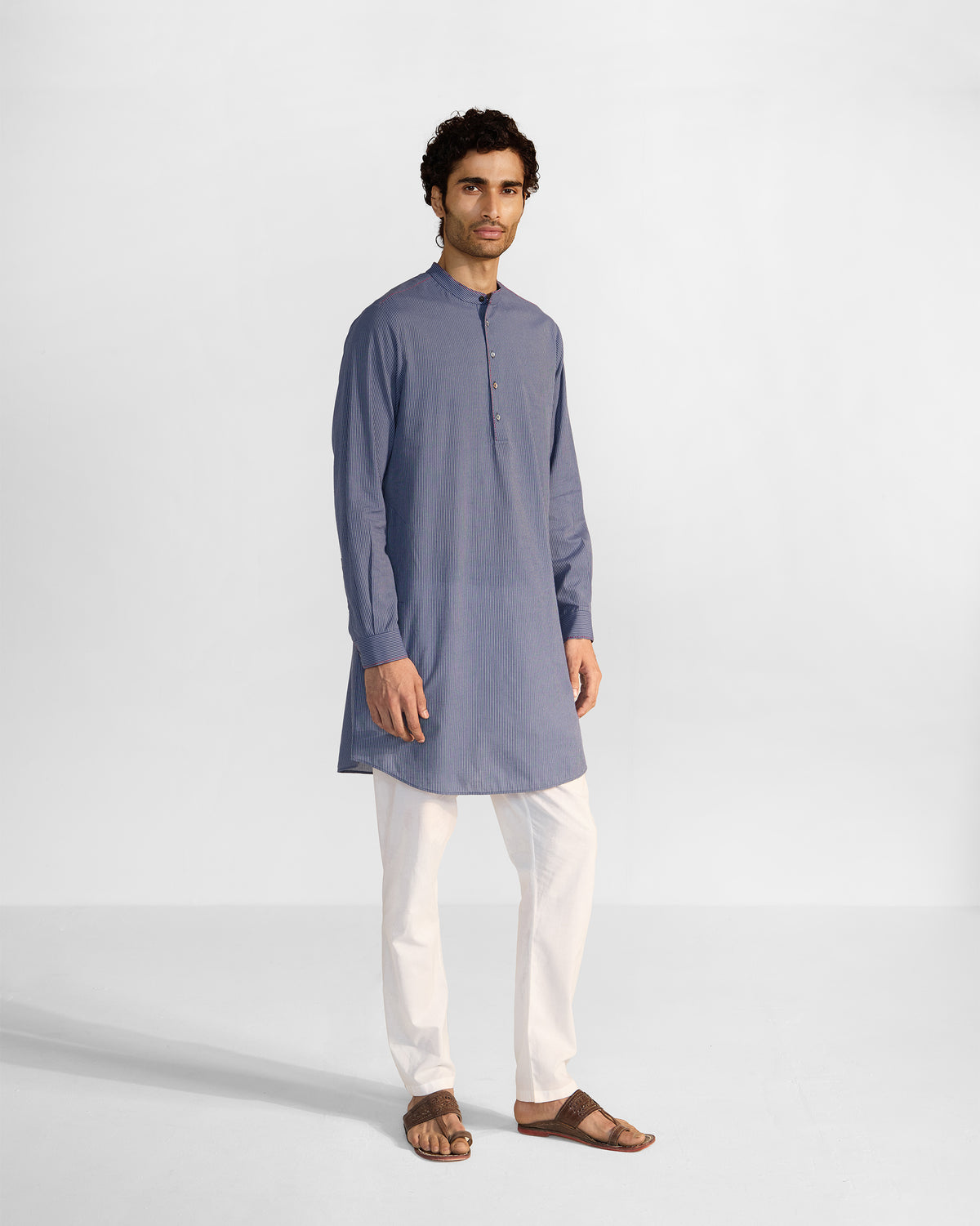Person wearing a navy and white striped Nysa Kurta at full length.