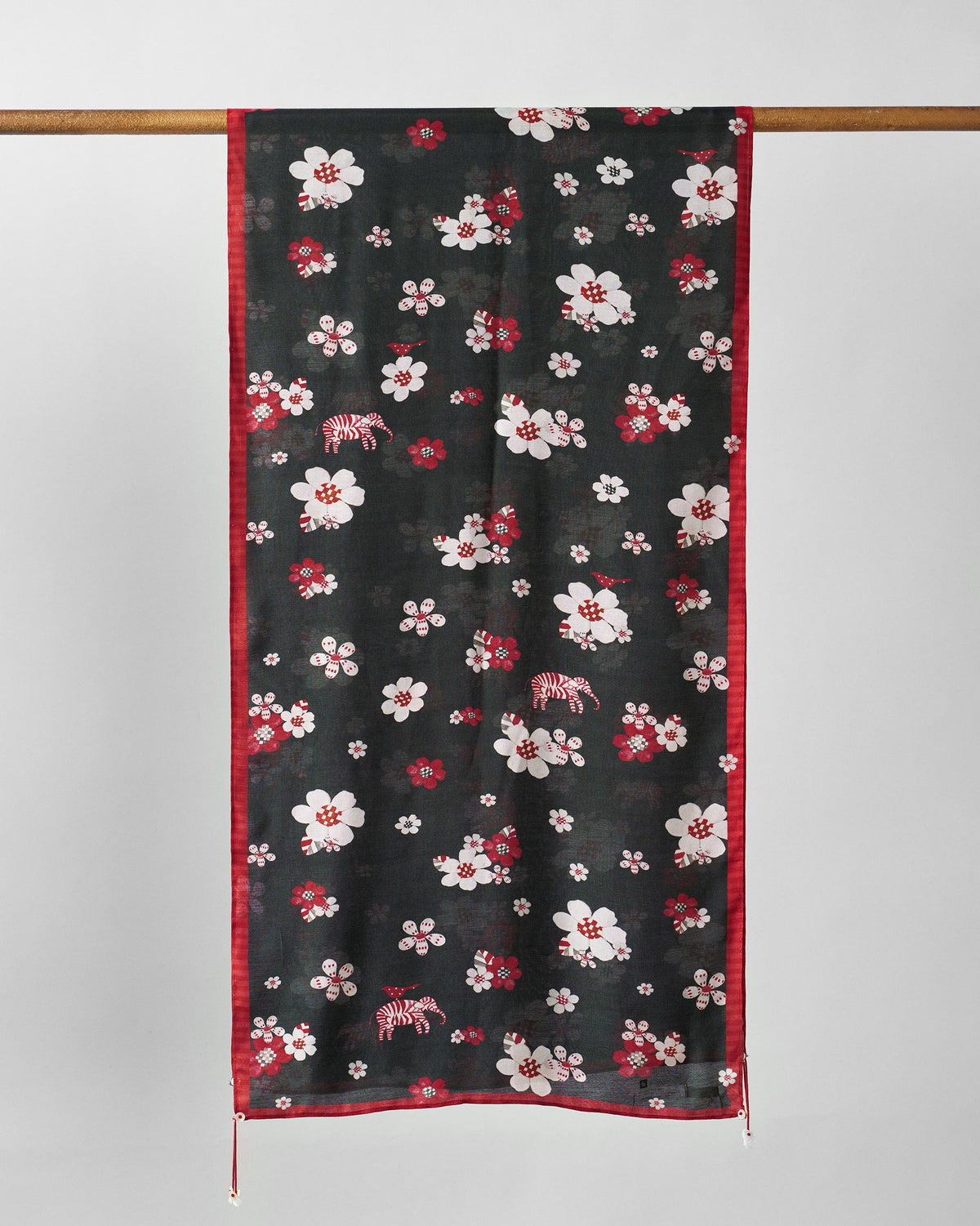 Fleur Scarf in red and black with a red border, hung full length.