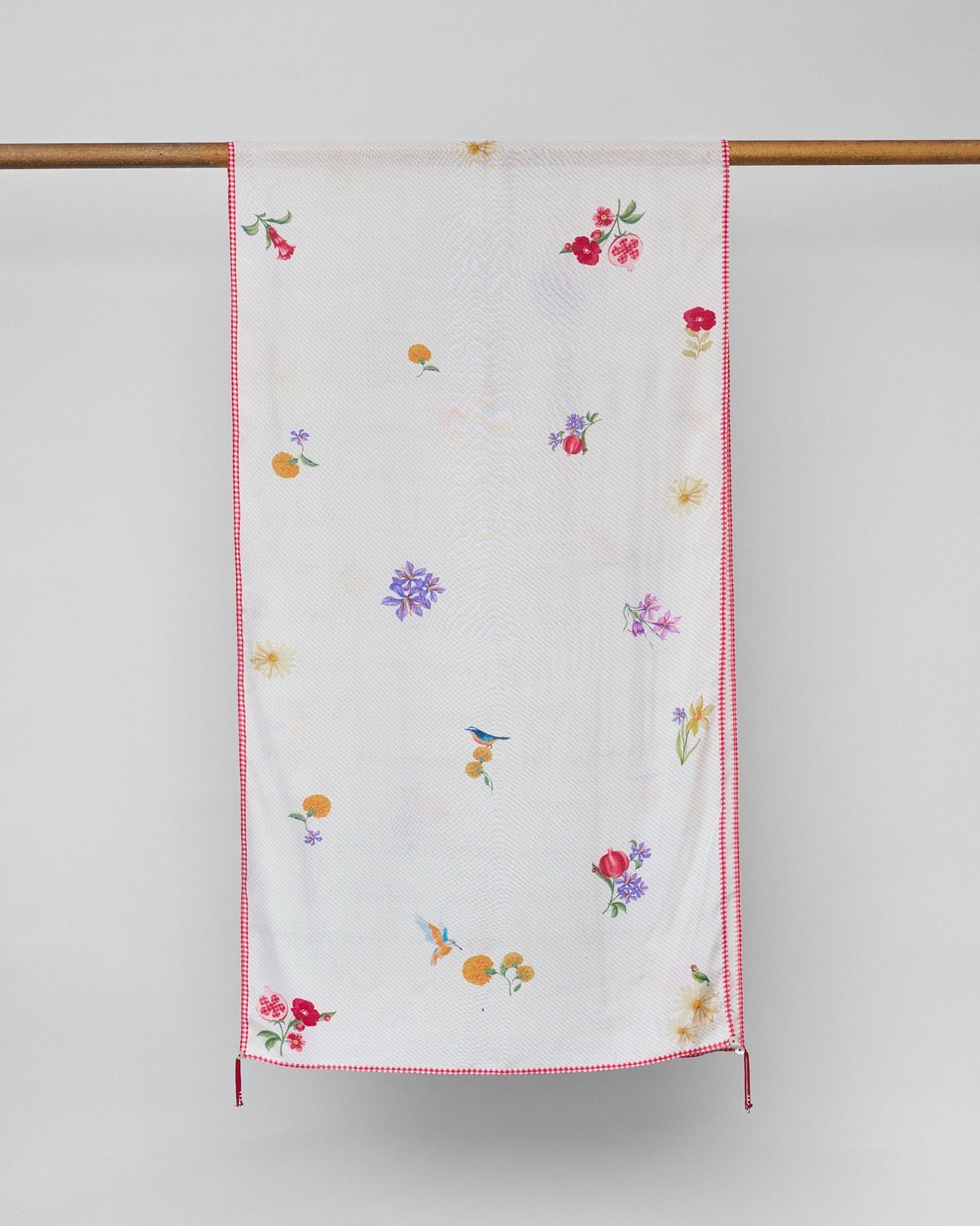 Floral Bloom scarf hung flat, showing small flowers and birds on ivory with red edging.