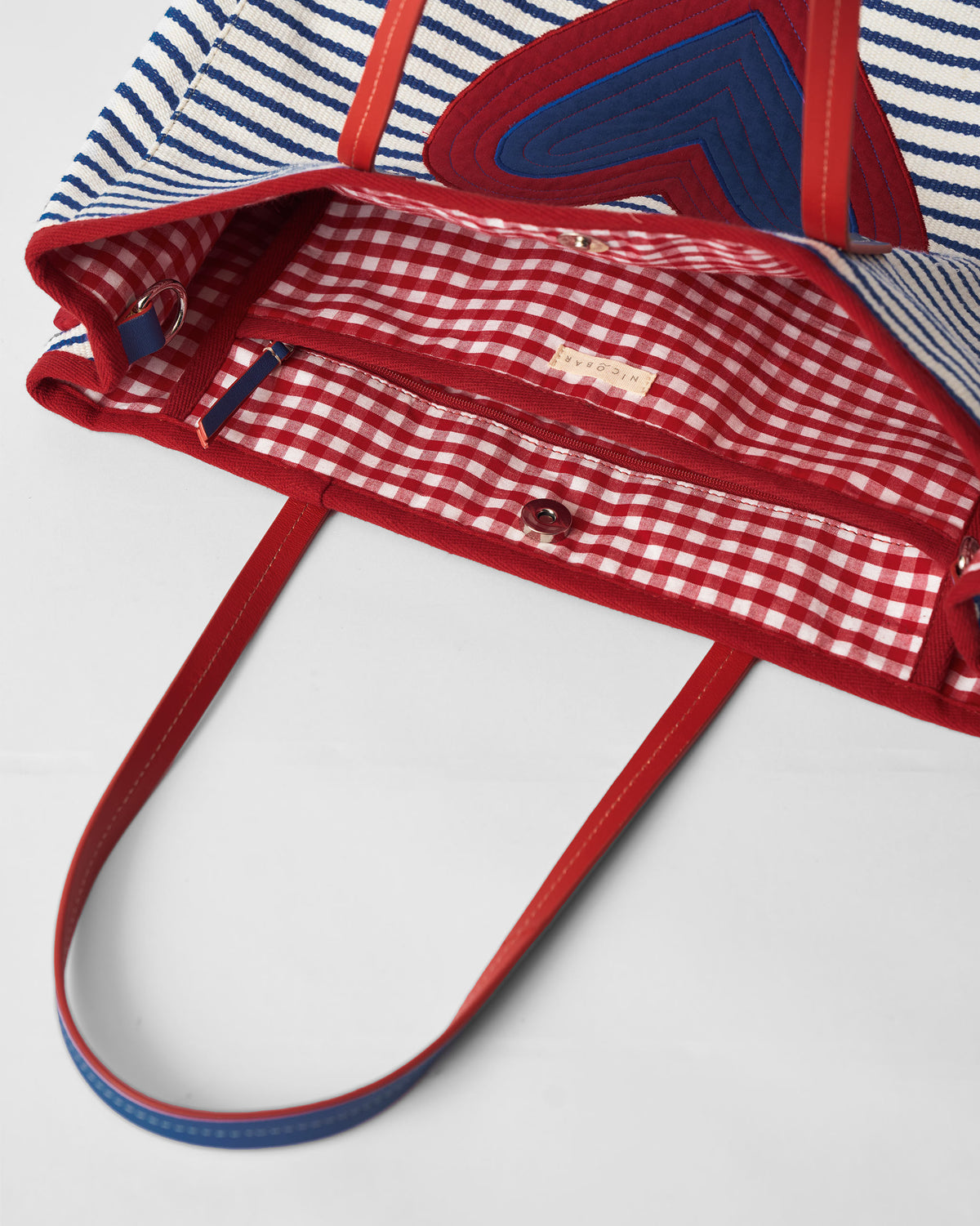 Open Kira Bag showing the red gingham lining and zip pocket.