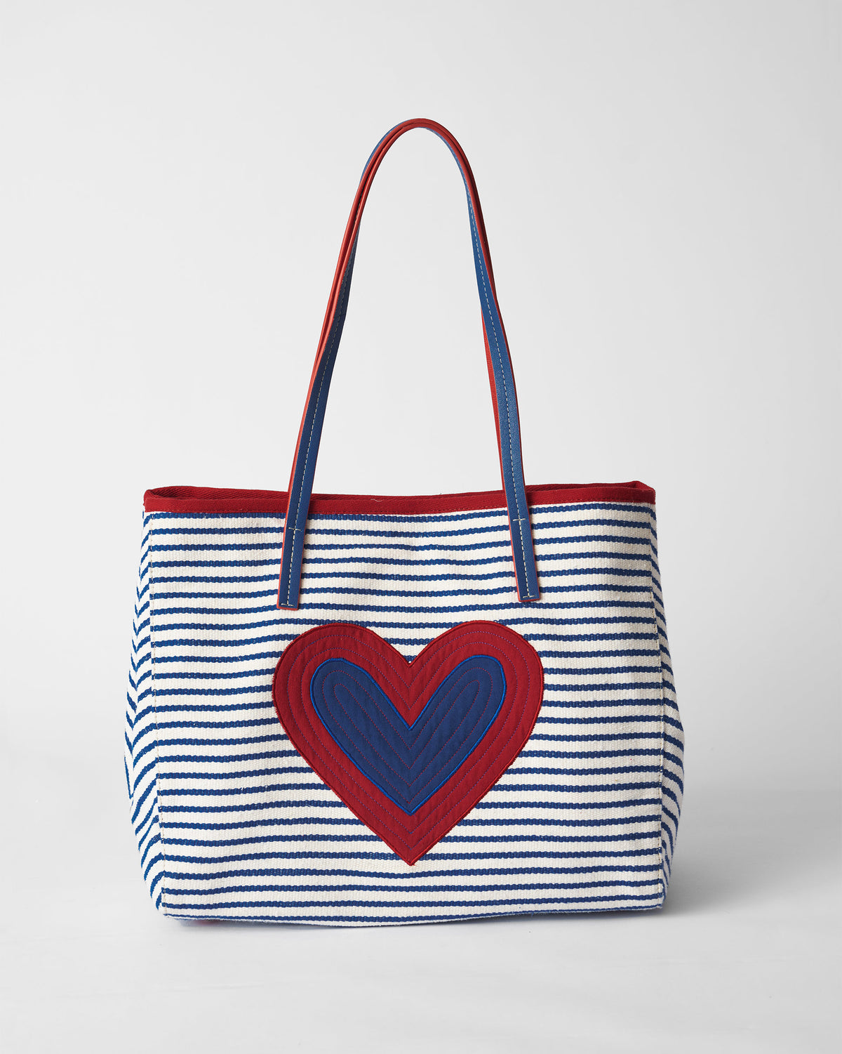 Blue and white striped Kira Bag with a quilted red and blue heart.