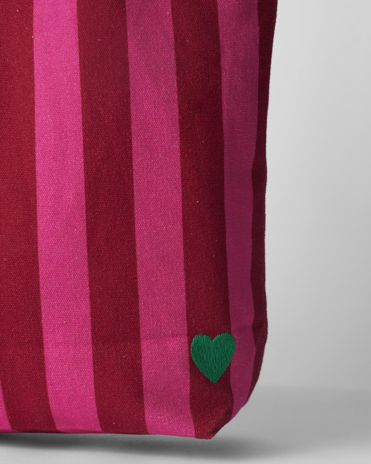 Close-up of a Mukayu city tote showing a green embroidered heart.