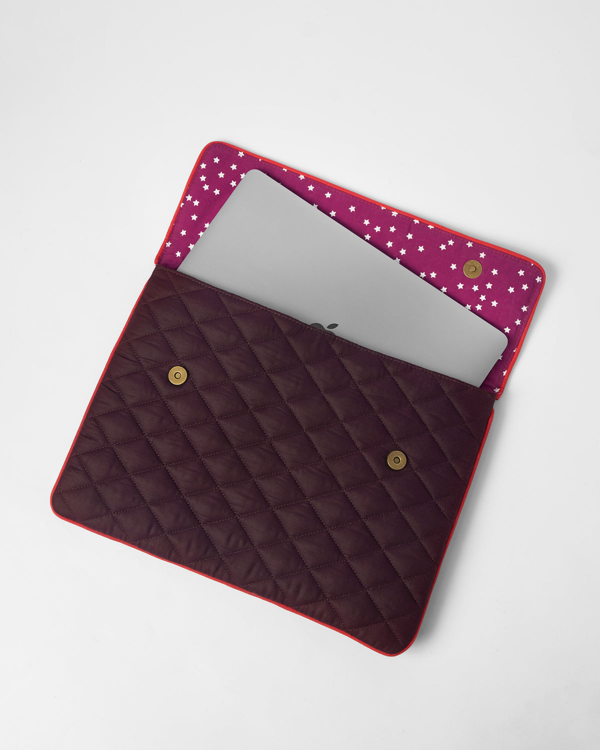 Open brown Ele laptop sleeve showing star-print lining and a laptop.