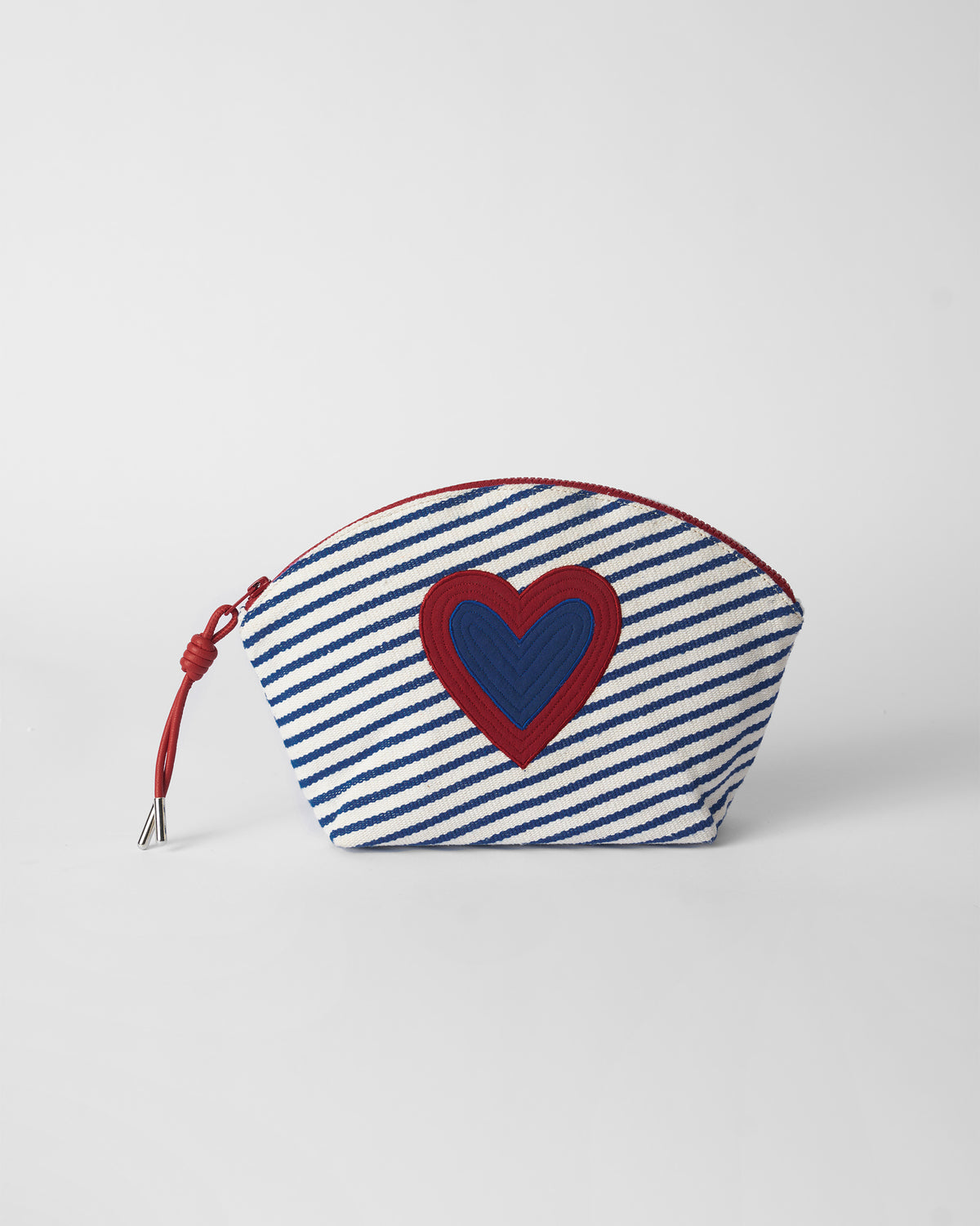 Blue and white Kira Pouch with a red heart and a red zipper cord.
