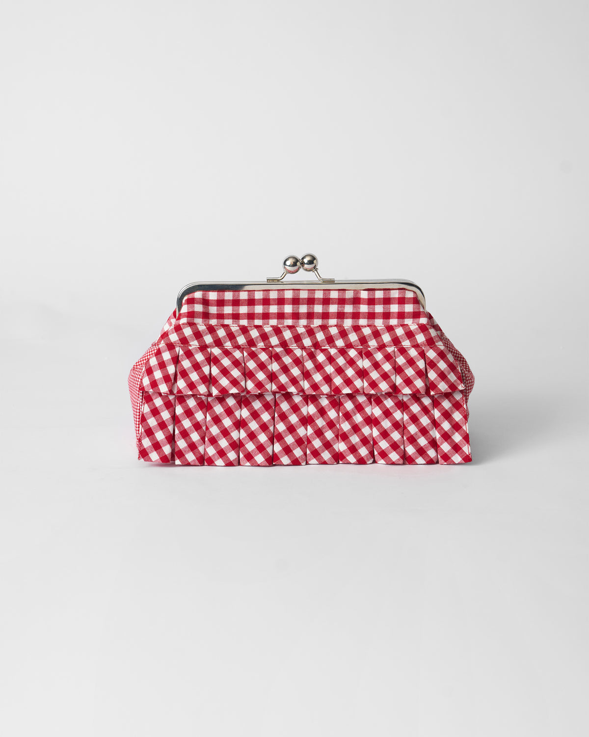 Red and white gingham Pleated Muse Clutch with tiered pleats and a silver clasp.