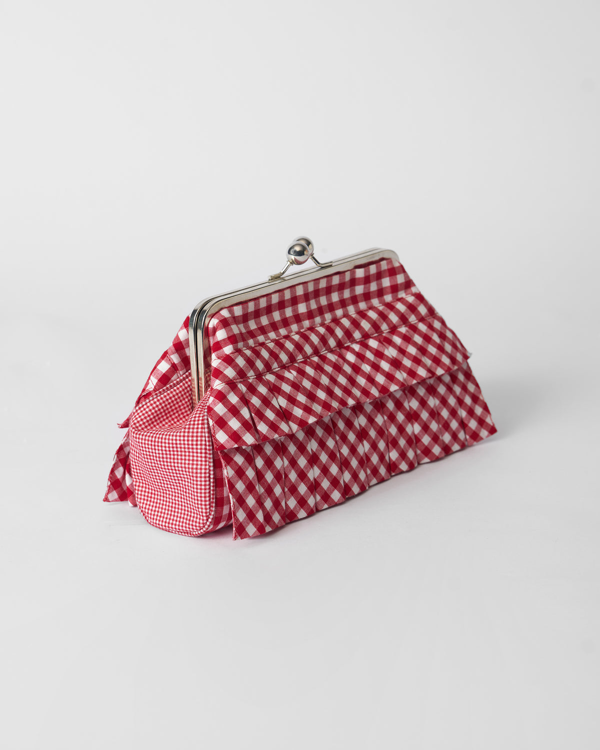 Red and white gingham Pleated Muse Clutch with tiered ruffles and a silver frame.