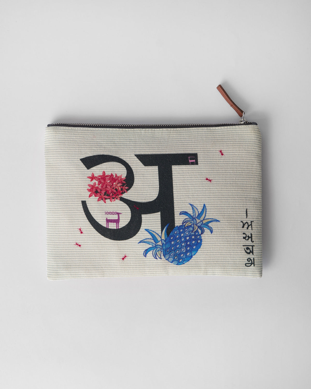 Ivory Anaar Pouch with a black अ letter and colorful botanical motifs.