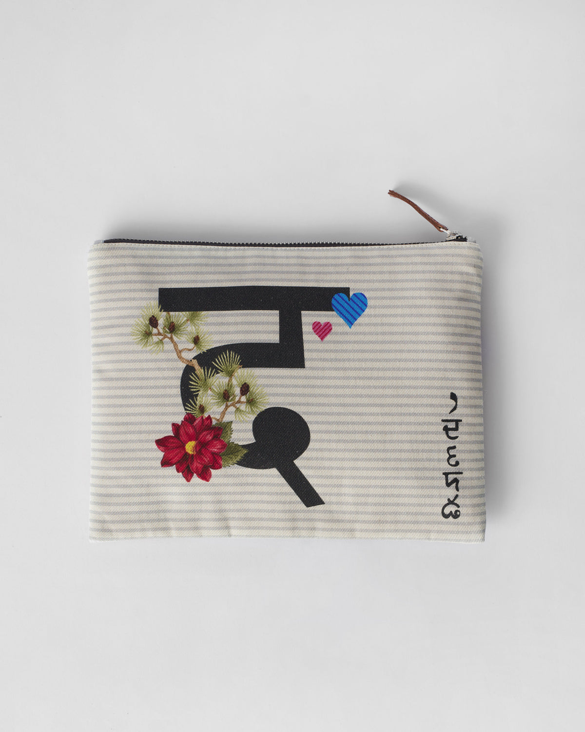 Ivory Dil Pouch with a black letter print, red flower, and striped hearts.