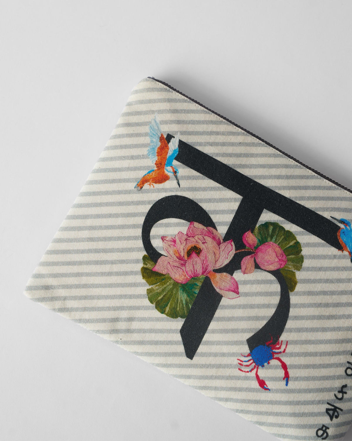 Close-up of the lotus and bird print on an ivory Kamal Pouch.