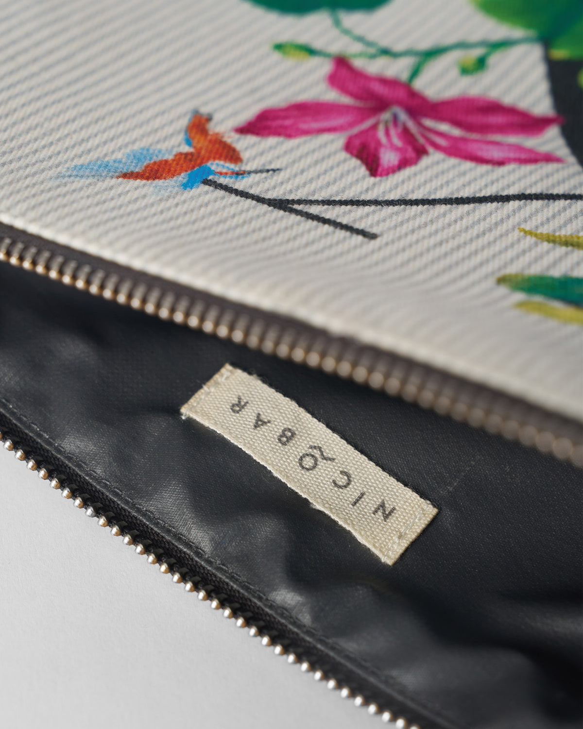 Open ivory Kamal Pouch showing the dark lining and Nicobar label.