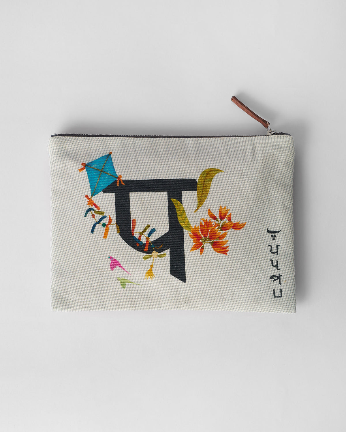 Ivory Palash Pouch with a black letter print, kite, and orange palash flowers.