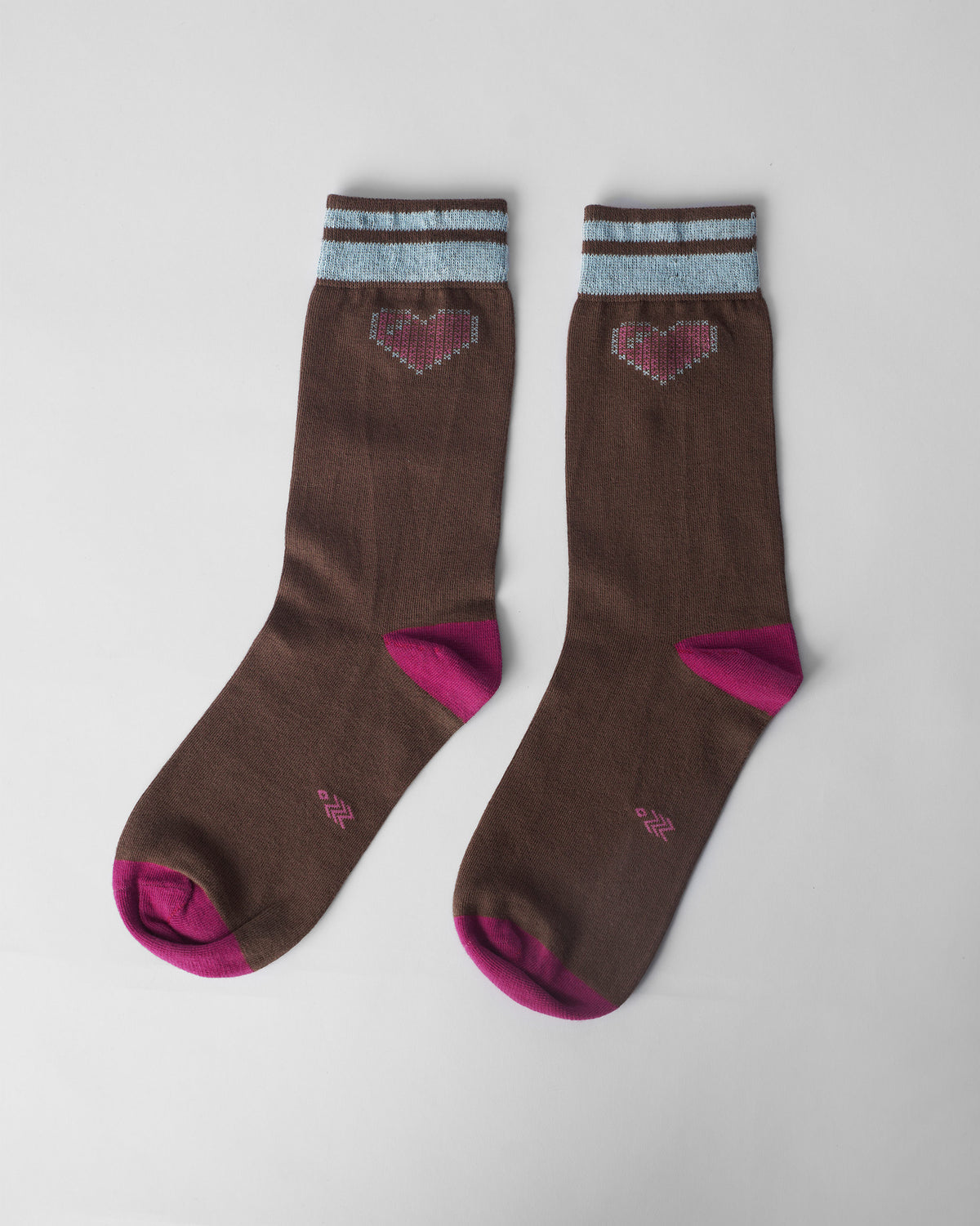 Pair of brown Pixel Heart Socks with fuchsia toes and pink pixel hearts laid flat.