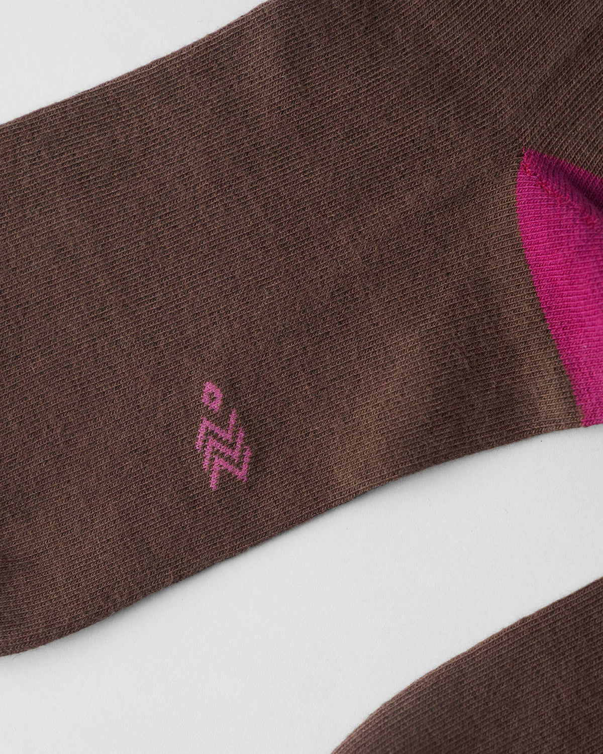 Close-up of brown Pixel Heart Socks showing the fuchsia heel.