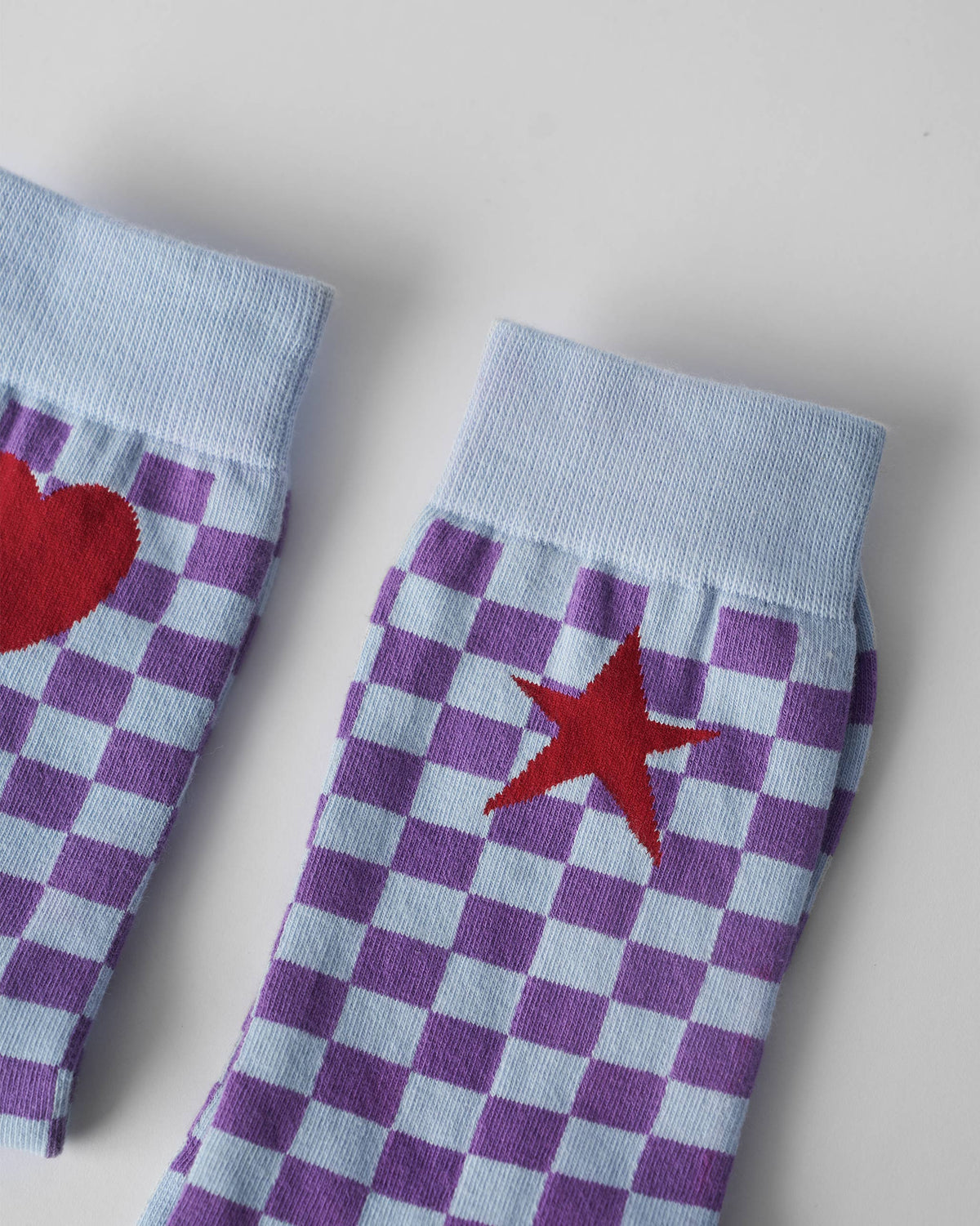 Close-up of heart and star motifs on Gingham Glow Socks.