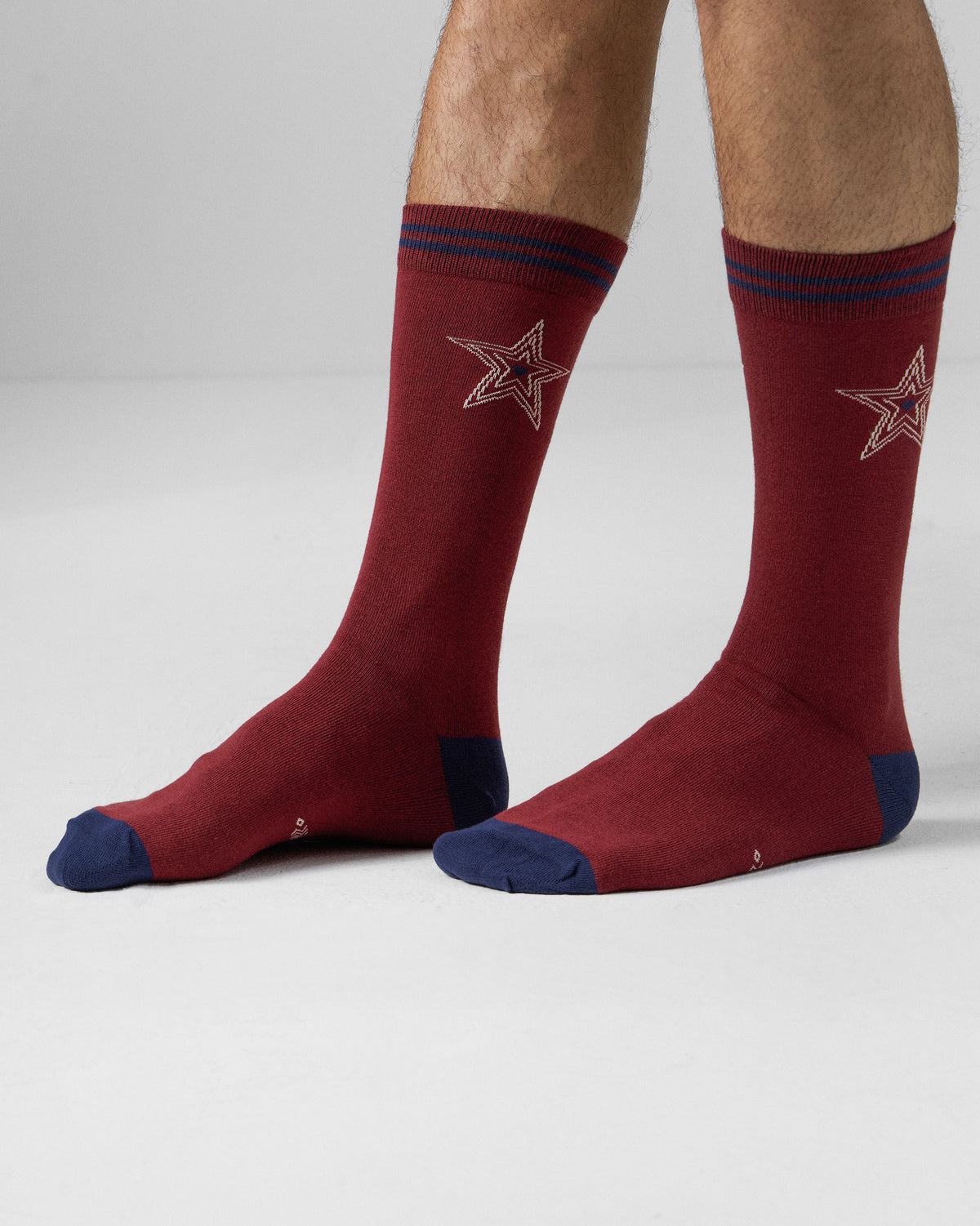 Maroon Starry socks worn mid-calf with navy accents and a cream star motif.