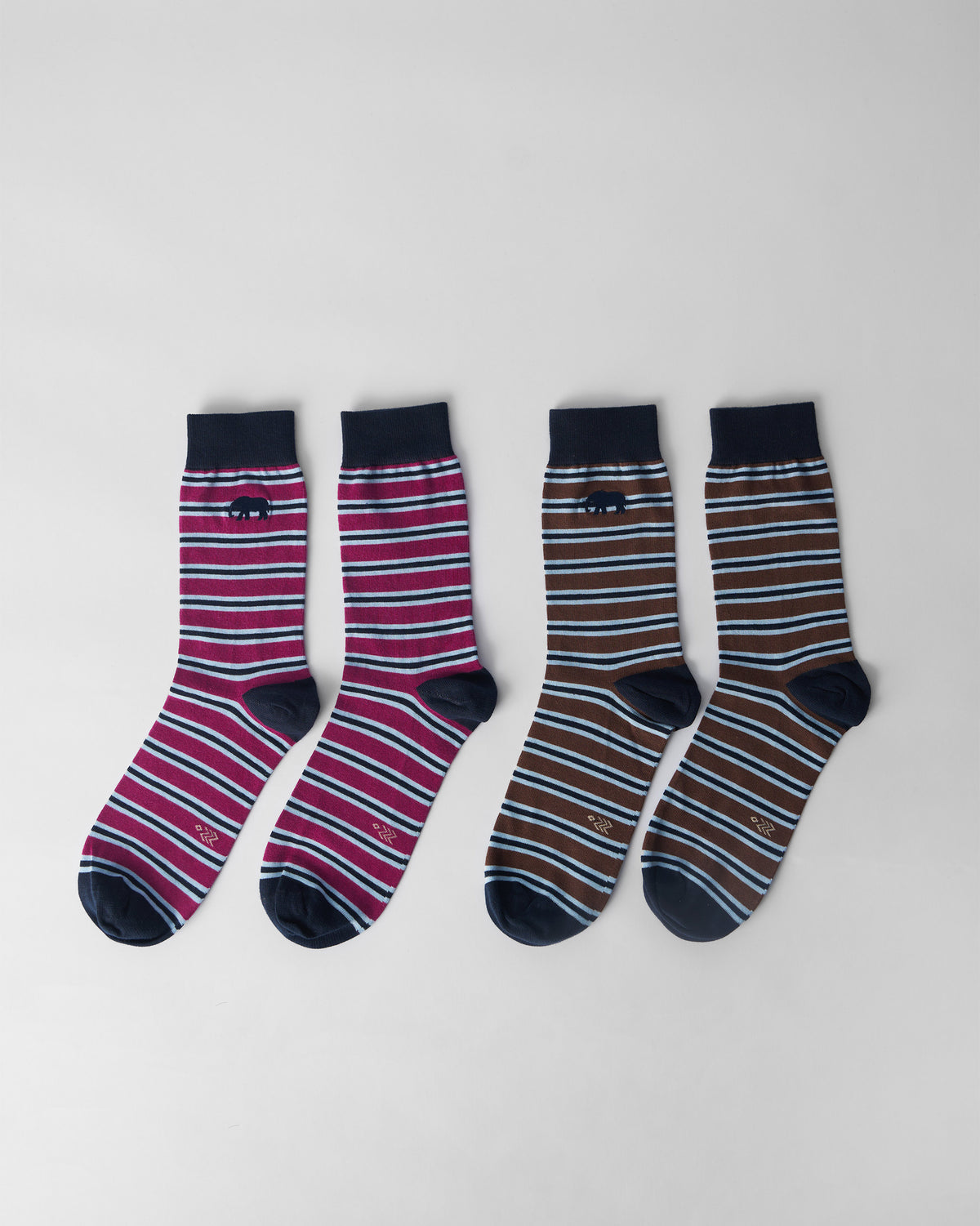 Stripey Socks set of two pairs flat lay, mulberry pink and brown stripes with navy cuffs and a small elephant motif.
