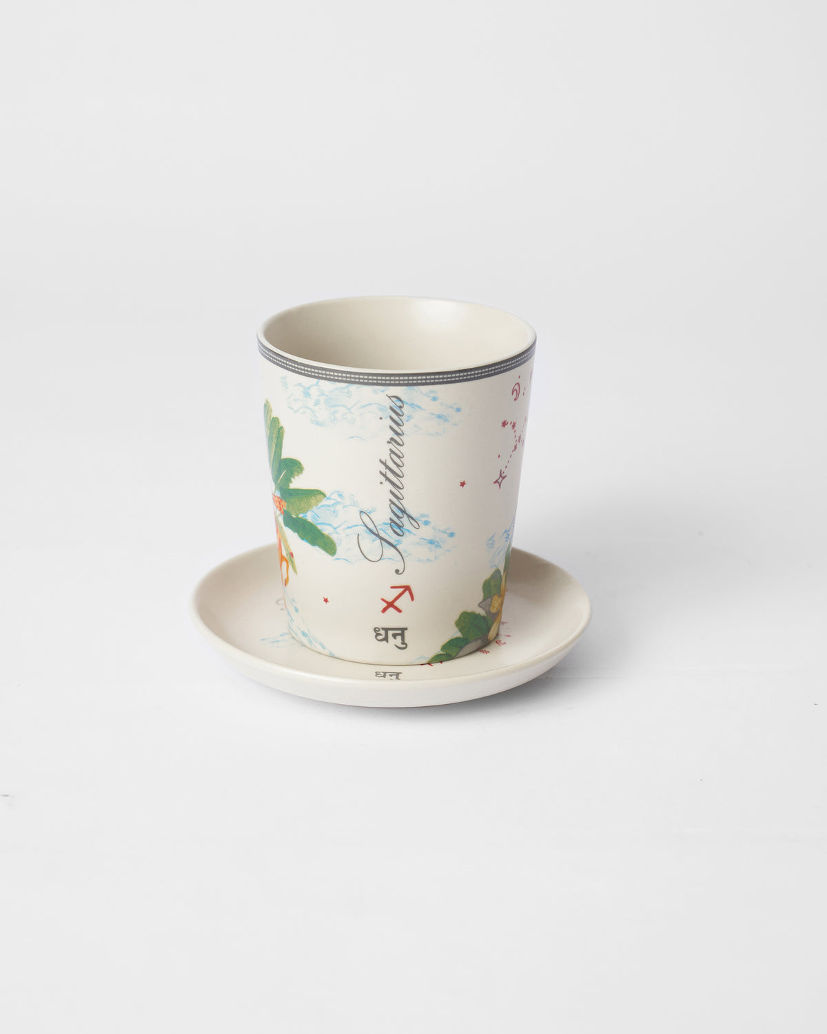 Nico Sagittarius cup on a plate with palm fronds and Dhanu text.