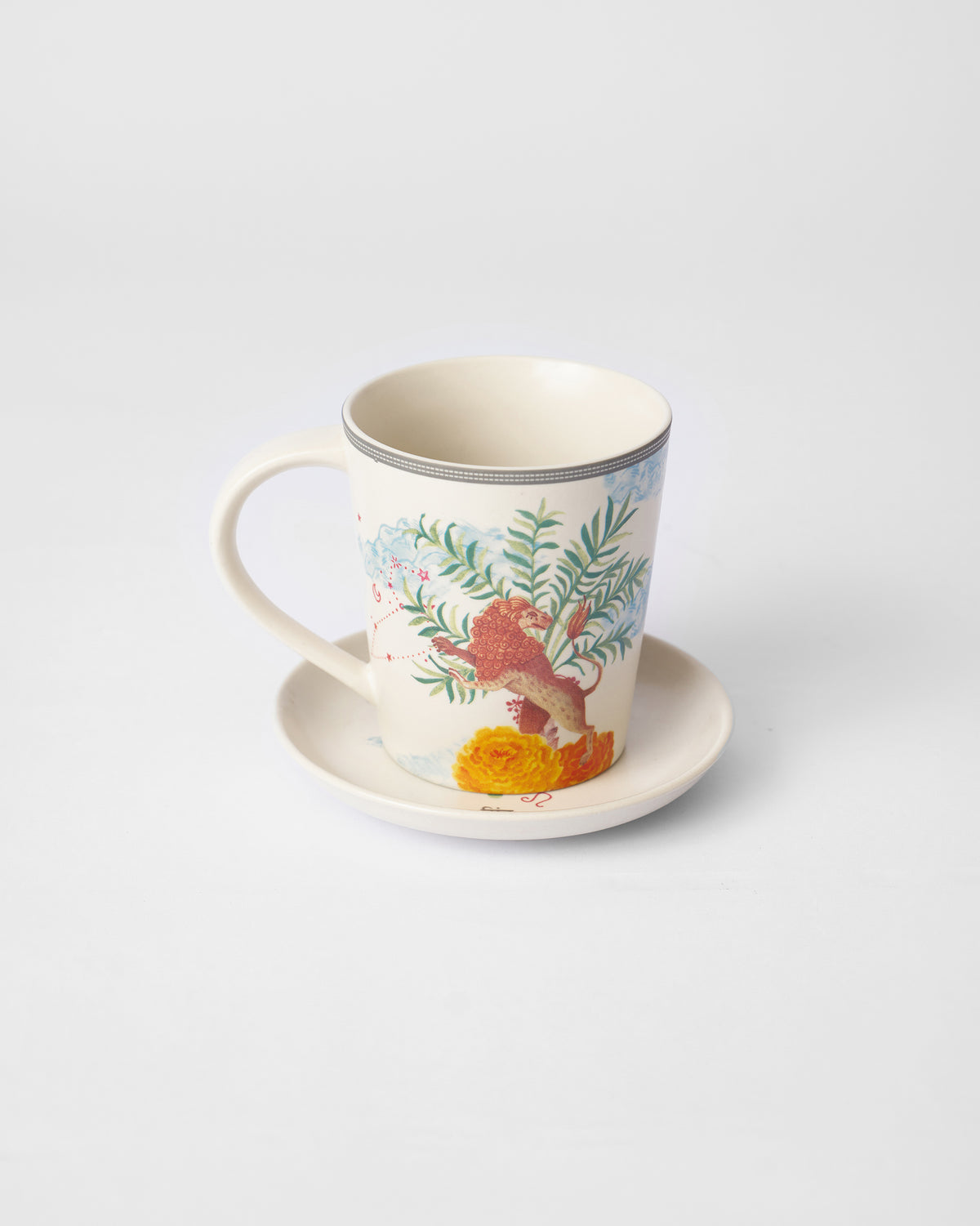 Nico Leo mug on its tea plate showing a lion among palm leaves.