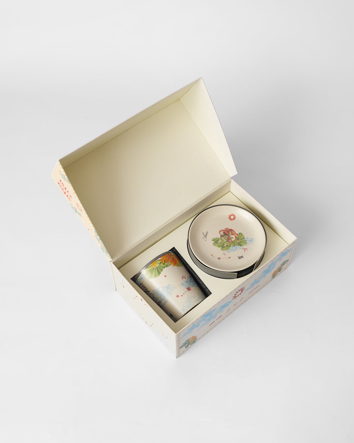 Nico Aries mug and tea plate packed in an open Nicobar gift box.